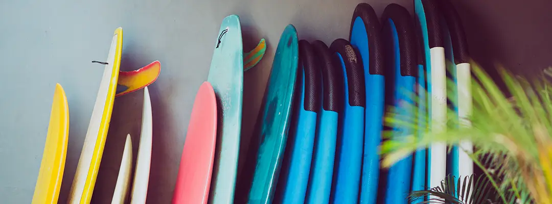 surfboards stacked against a wall