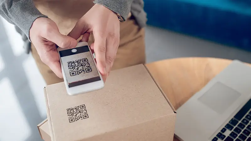 man holding a phone scanning a QR code