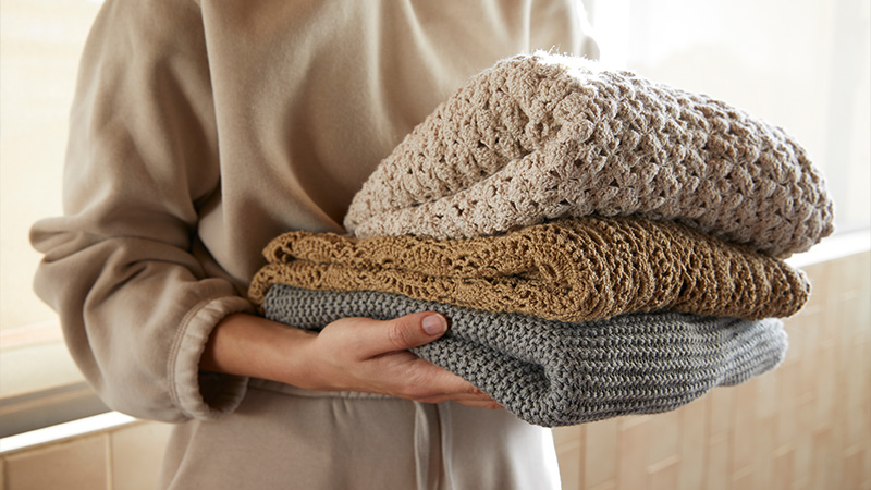 woman holding knitwear