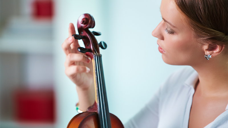 woman tuning violin