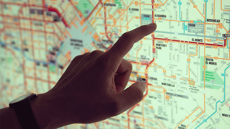finger pointing at map