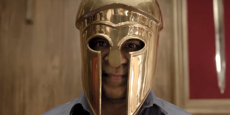 Man in gold Roman helmet 