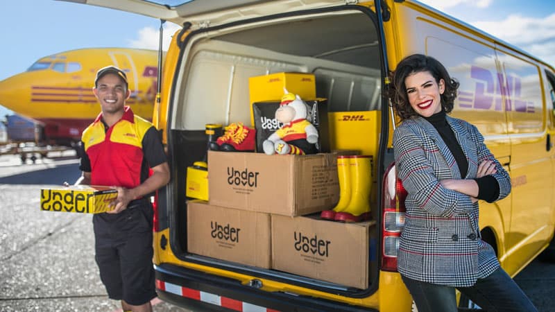 woman stand by a DHL van with a DHL courier