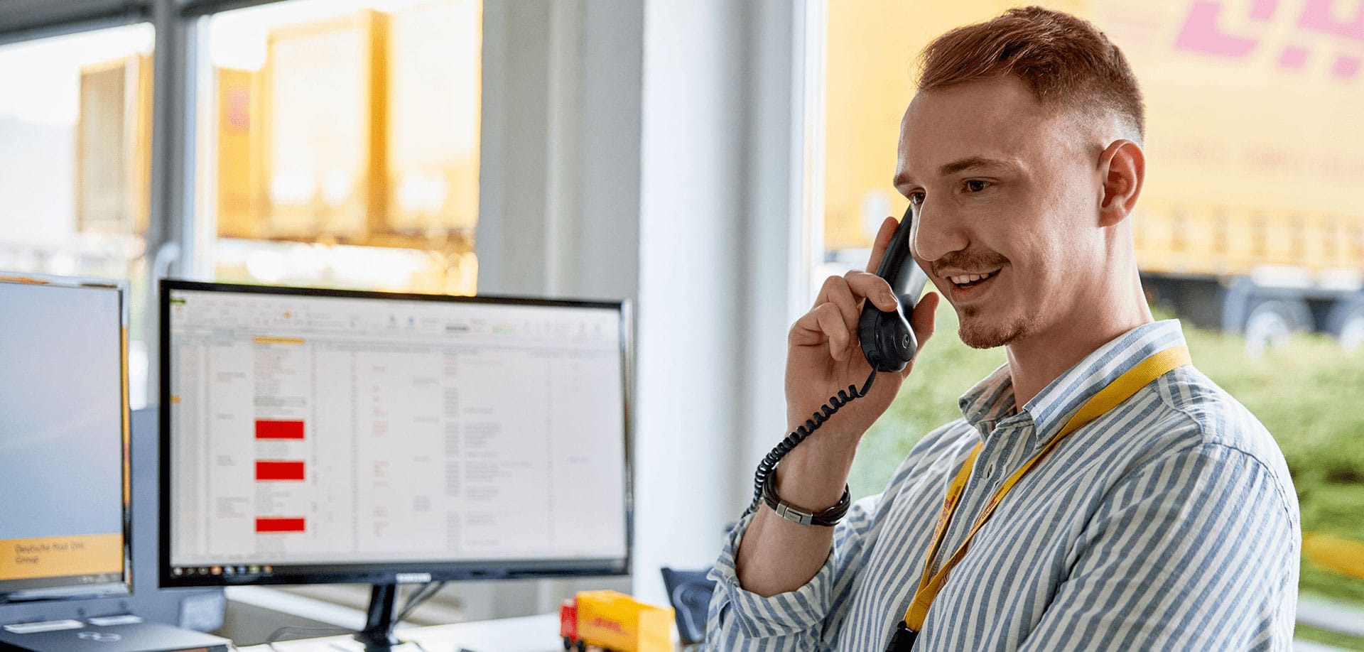 A DHL operative speaking to a customer on the phone