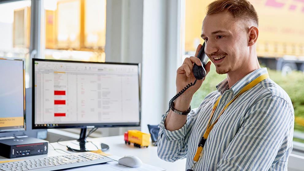 A DHL operative speaking to a customer on the phone