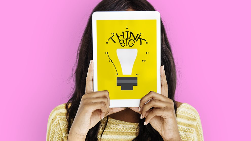 woman holding tablet with Think Big written on it