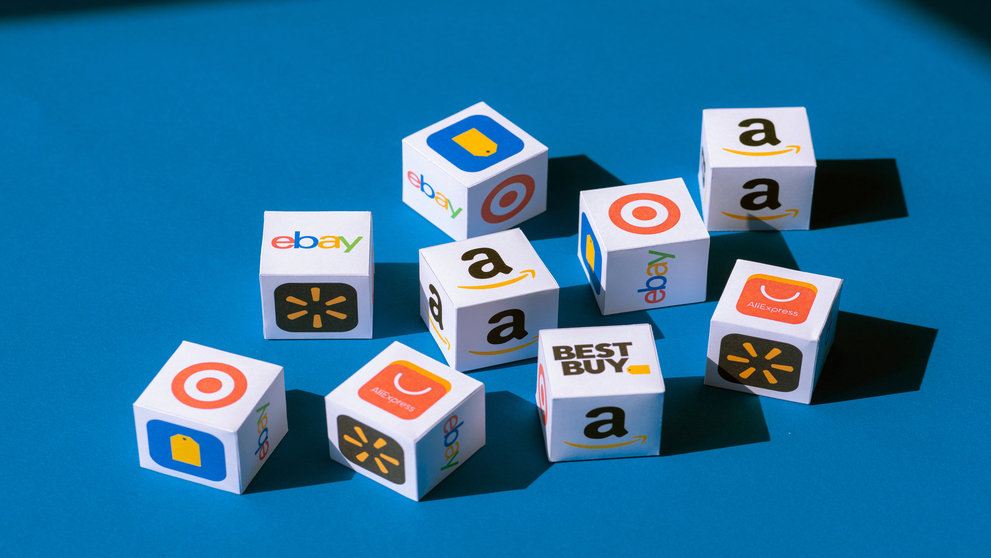 Kyiv, Ukraine - September 10, 2019: A paper cubes collection with printed logos of eCommerce corporations and online retail stores, such as AliExpress, WallMart, eBay, Amazon, and others.