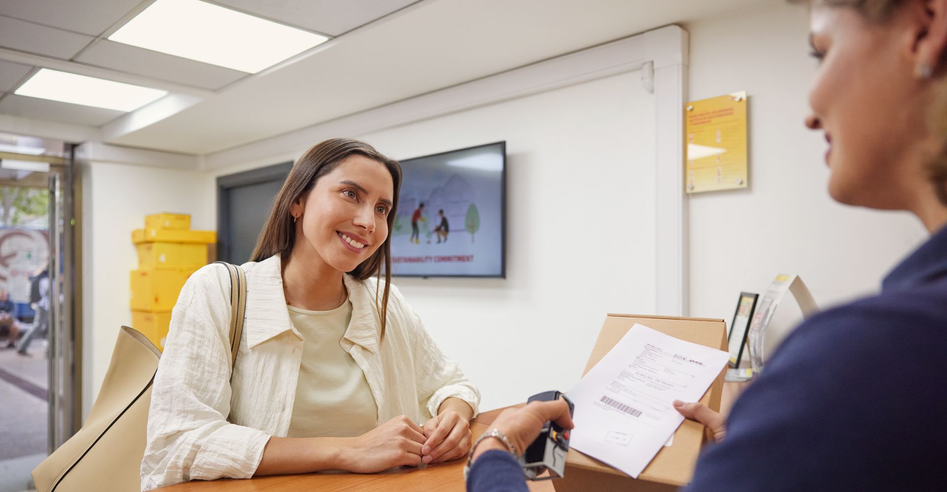 woman sending an overseas shipment with an air waybill at dhl express