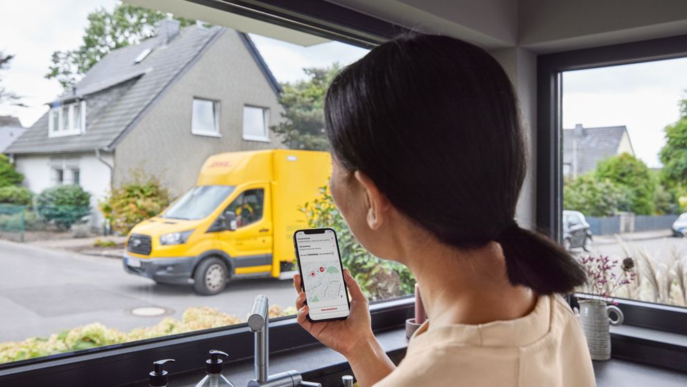 woman using AI in last mile delivery to track her parcel on a smartphone