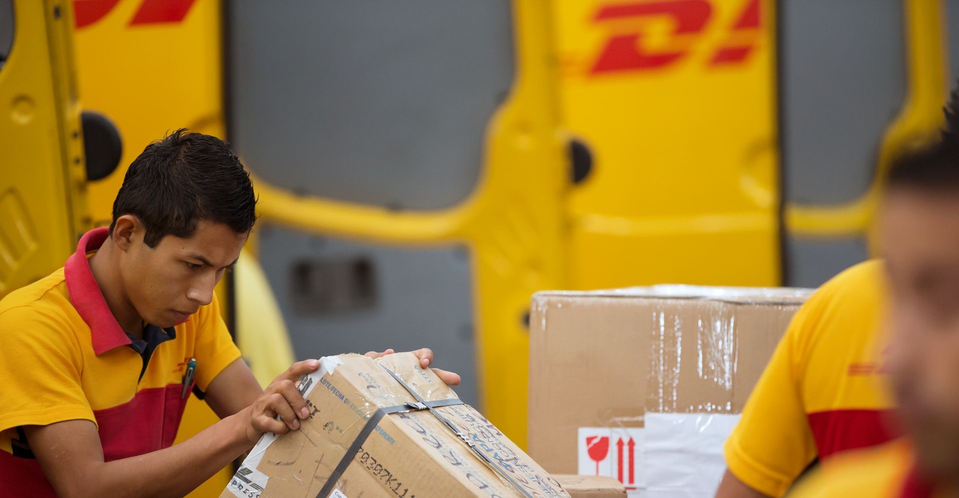 dhl express employee checking fragile items for shipping