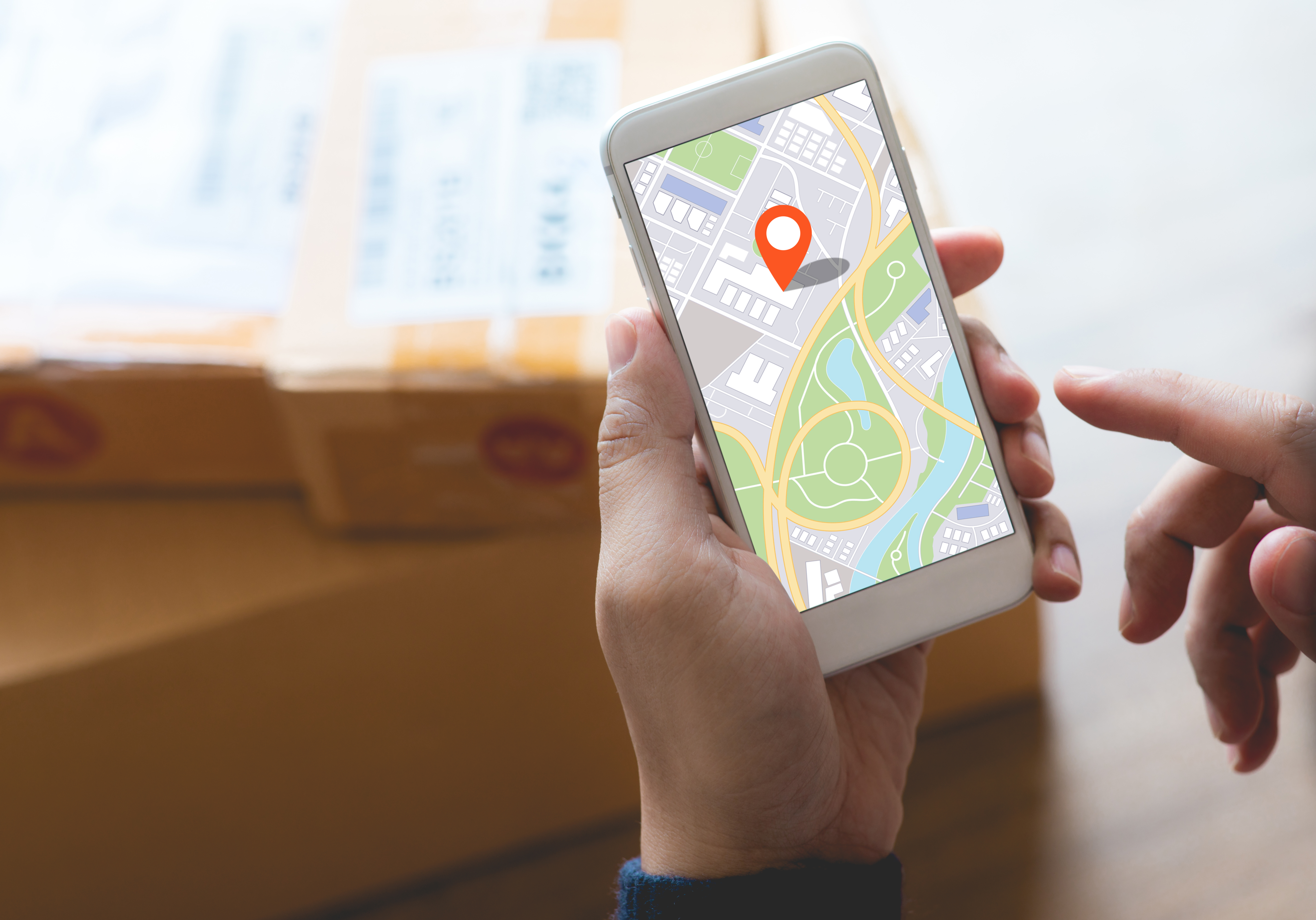 Delivery and online shopping concepts with young person using digital map with smartphone on product package box.Ecommerce market.Transportation logistic.Business retail.