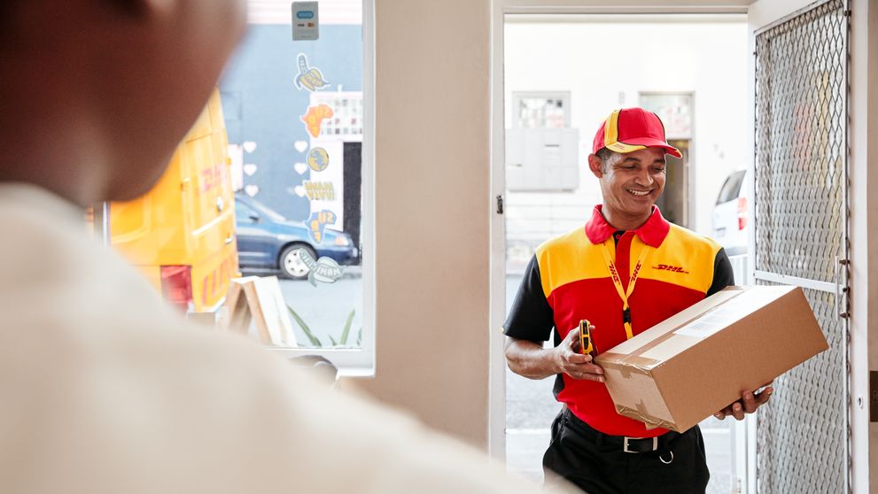 dhl express employee delivering a parcel