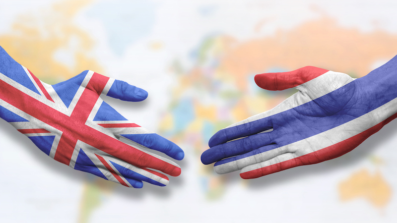 Thailand and UK - Flag handshake symbolizing partnership and cooperation with the United Kingdom